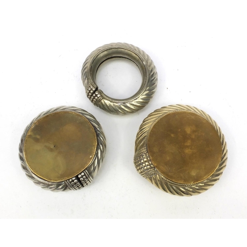 331 - Three Middle Eastern silver coloured metal ankle bracelets, the largest 13cm in diameter