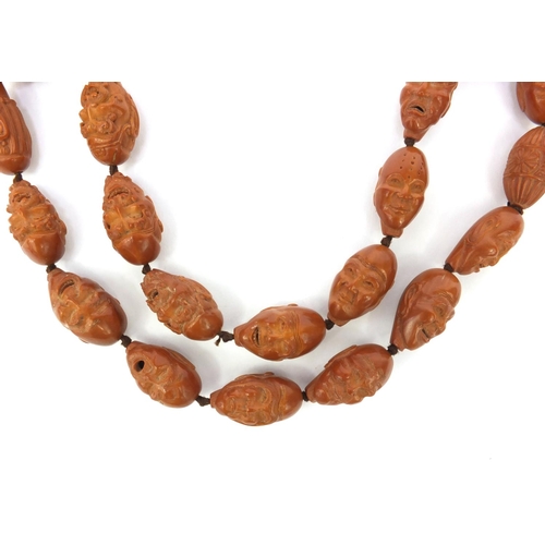 532 - Chinese carved coquilla nut necklace, the nuts each carved with different expressive faces, the neck... 