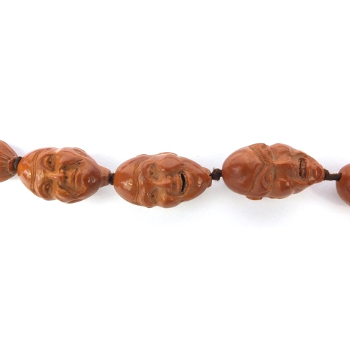 532 - Chinese carved coquilla nut necklace, the nuts each carved with different expressive faces, the neck... 