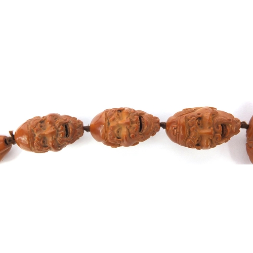 532 - Chinese carved coquilla nut necklace, the nuts each carved with different expressive faces, the neck... 