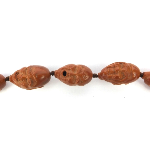 532 - Chinese carved coquilla nut necklace, the nuts each carved with different expressive faces, the neck... 