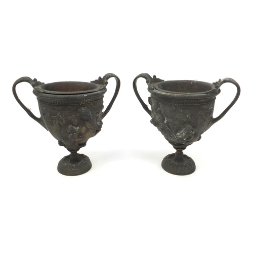 37 - Pair of brass twin handled urns both embossed with classical scenes, both with liners, each 16cm hig... 