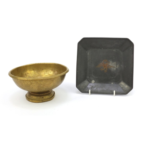 56 - Brass footed bowl together with a square pewter dish inlaid with a mythical bird, both with impresse... 