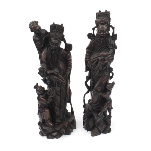 551 - Large pair of Chinese carved root figures, both of elders with children, the tallest 62cm high