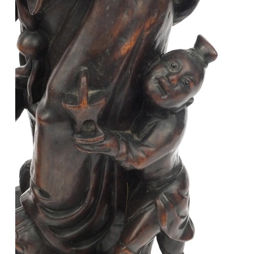 551 - Large pair of Chinese carved root figures, both of elders with children, the tallest 62cm high