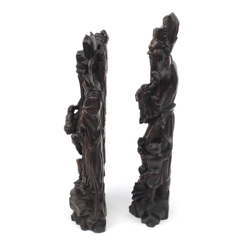 551 - Large pair of Chinese carved root figures, both of elders with children, the tallest 62cm high