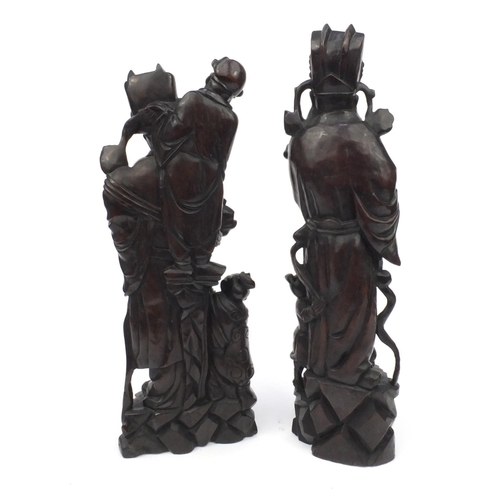 551 - Large pair of Chinese carved root figures, both of elders with children, the tallest 62cm high