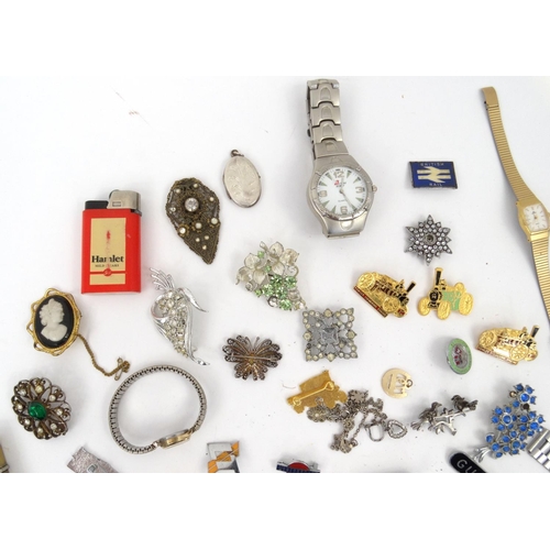 383 - Box of assorted costume jewellery, including wristwatches, locomotive pin badges, brooches, lighters... 