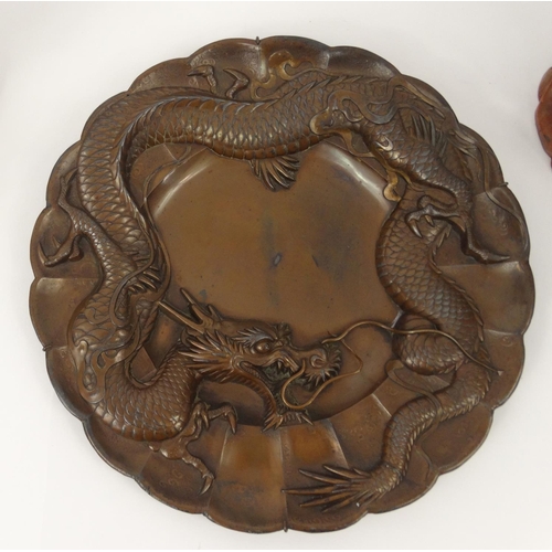 211 - Oriental items compromising of a carved Buddha, carved soapstone koro with cover and a bronzed plate... 