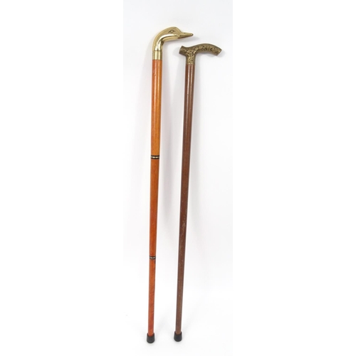 468 - Two walking sticks - one with a ducks head handle