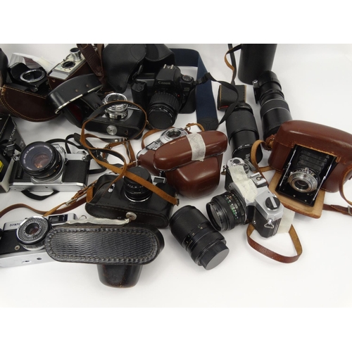 216 - Large selection of cameras, lenses and accessories including Cannon, Nikon, Vivitar and Kodak exampl... 