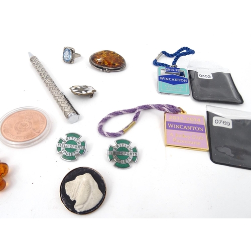 369 - Small selection of costume jewellery and enamelled badges including a silver and natural amber brooc... 