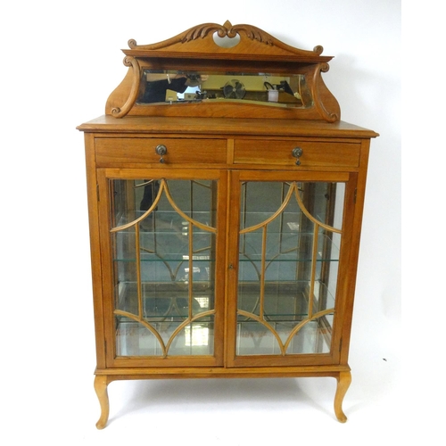 102 - Walnut display cabinet fitted with two frieze drawers and mirrored back, 140cm high x 91cm wide x 38... 