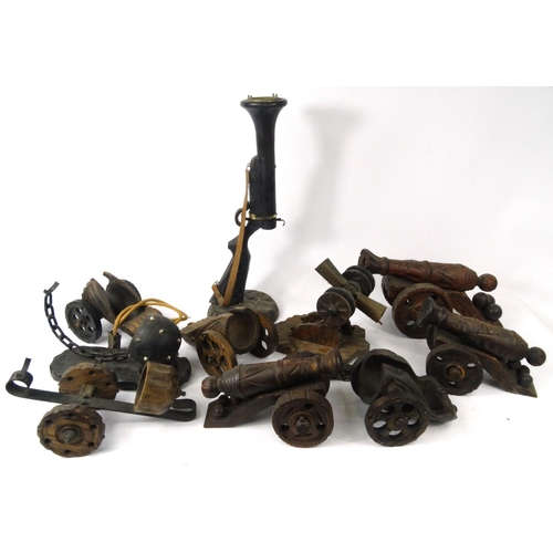 300 - Collection of carved wooden model cannons, and wine bottle holders, together with a Blunderbuss smok... 