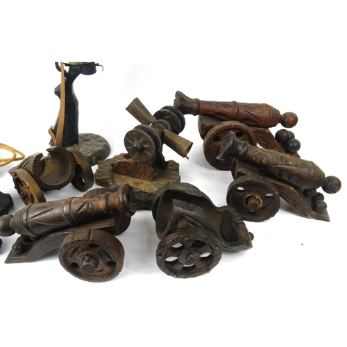 300 - Collection of carved wooden model cannons, and wine bottle holders, together with a Blunderbuss smok... 