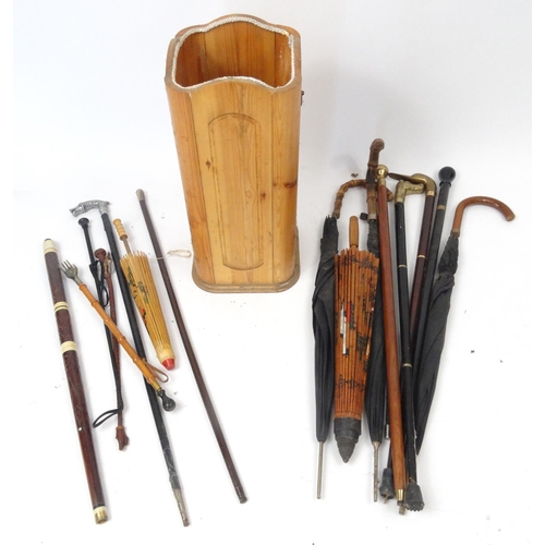 121 - Collection of walking sticks, umbrellas and parasols, some with brass animal head handles, with a pi... 