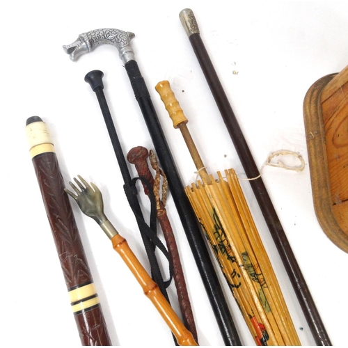 121 - Collection of walking sticks, umbrellas and parasols, some with brass animal head handles, with a pi... 