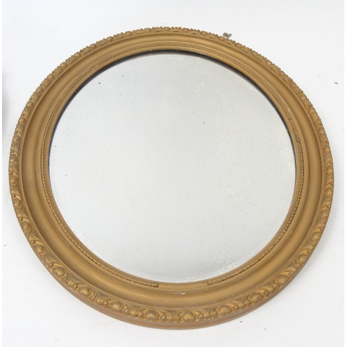 75 - Two ornate oval gilt framed mirrors, one with Putti decoration, the larger approximately 64cm x 41cm