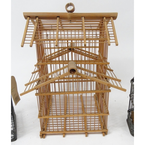 339 - Three metal and wooden bird cages, the larger 46cm high