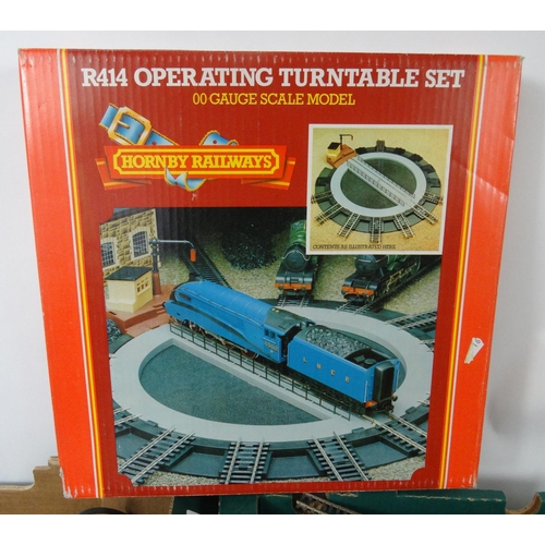 287 - Four boxes of model railway, carriages, track, trackside buildings etc. including Hornby examples