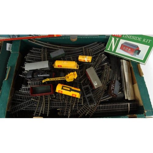 287 - Four boxes of model railway, carriages, track, trackside buildings etc. including Hornby examples