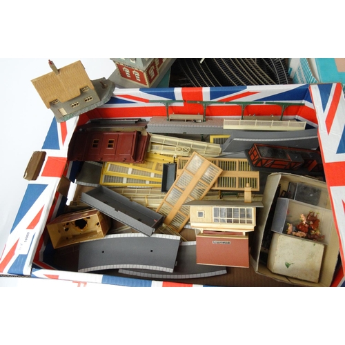 287 - Four boxes of model railway, carriages, track, trackside buildings etc. including Hornby examples