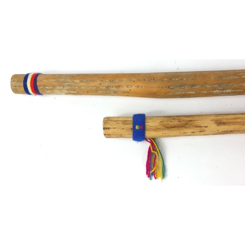 465 - Two African rainmakers, larger 123cm long