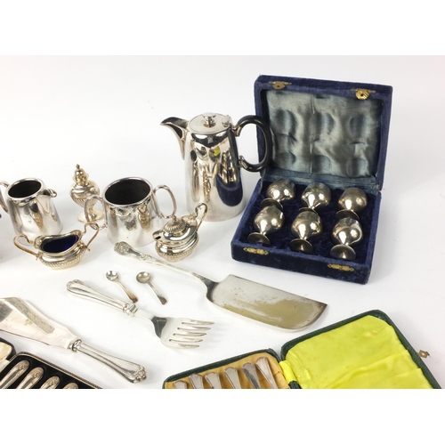 265 - Silver plated items including a tea service, cruets, case set of six silver handled butter knifes et... 