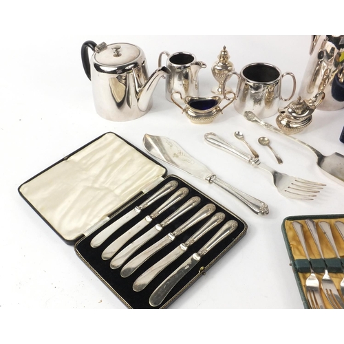 265 - Silver plated items including a tea service, cruets, case set of six silver handled butter knifes et... 