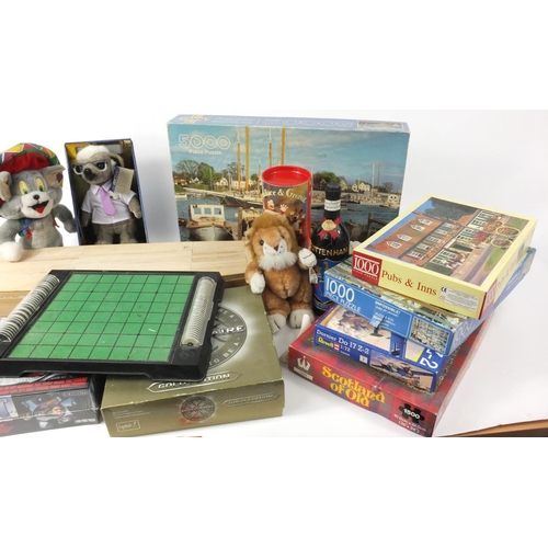 522 - Box of assorted games and jigsaw puzzles and a large part built model yacht