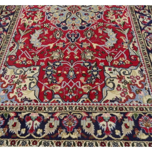 63 - Blue ground geometric floral patterned rug with Persian  rug world label, approximately 160cm x 107c... 