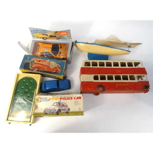 463 - Box of children's model vehicles including a sports car, wooden bus etc, with two albums of world st... 