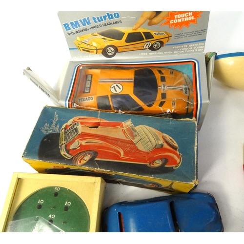 463 - Box of children's model vehicles including a sports car, wooden bus etc, with two albums of world st... 