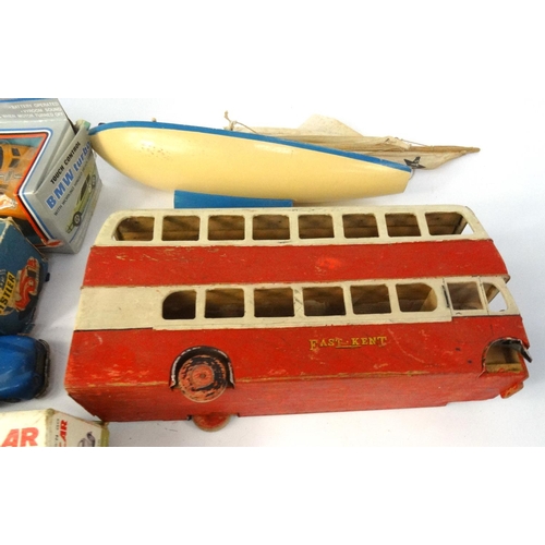 463 - Box of children's model vehicles including a sports car, wooden bus etc, with two albums of world st... 