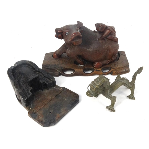 456 - Oriental carved wooden figure on a buffalo, soapstone carving and a brass dragon