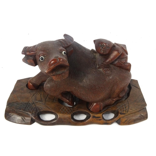 456 - Oriental carved wooden figure on a buffalo, soapstone carving and a brass dragon