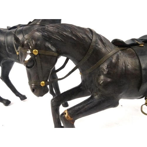 543 - Two leather model horses, the largest approximately 32cm high