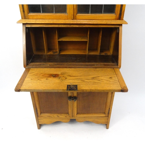 6 - Light oak bureau bookcase fitted with leaded glass doors, 190cm high x 76cm wide x 31cm deep