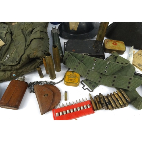 620 - Box of military items, including tin helmet, ammunition belt, gas mask, enamelled bottle etc.