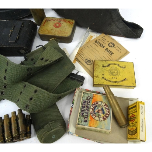 620 - Box of military items, including tin helmet, ammunition belt, gas mask, enamelled bottle etc.