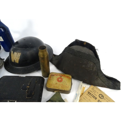 620 - Box of military items, including tin helmet, ammunition belt, gas mask, enamelled bottle etc.