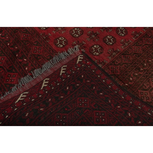 59 - Hand knotted wool pile red ground geometric carpet, approximately 300cm x 200cm