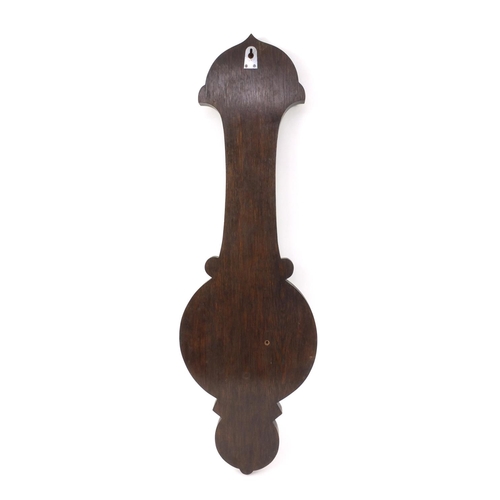 313 - Carved oak aneroid barometer with a presentation plaque, 84cm high