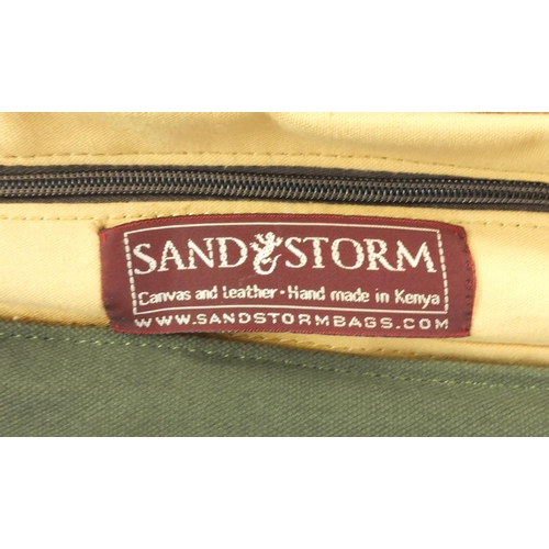 311 - Two Sand Storm canvas and leather bags, the largest 60cm wide