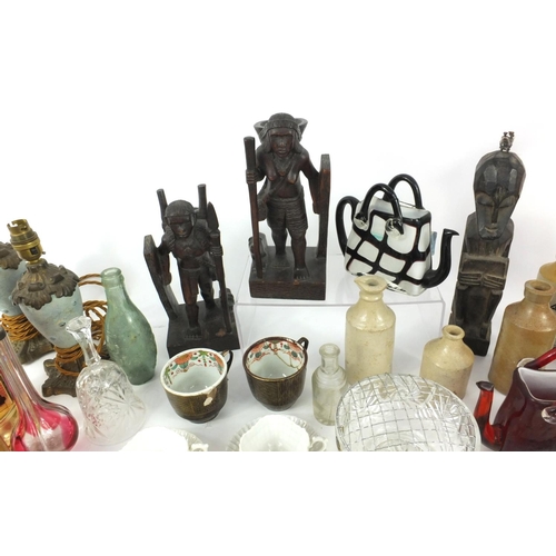 509 - Box of items including wooden figures, Oriental porcelain cups, glass handbag shaped teapot etc.