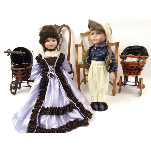 274 - Dolls and accessories including a boy and a girl on a stand, two dolls prams and two dolls chairs