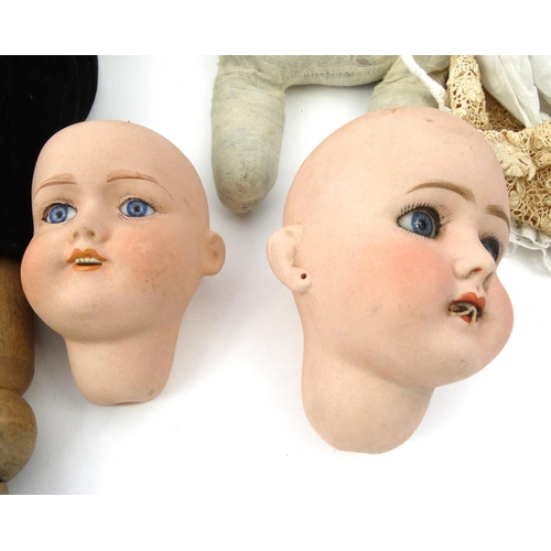 281 - Bisque dolls heads and a large wooden doll