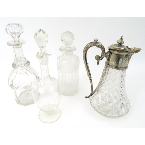 458 - Three cut glass decanters with stoppers and a glass and silver plated claret jug