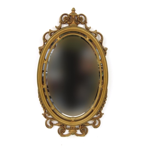 2043 - Ornate gilt framed mirror decorated with urns and swags, 80cm high