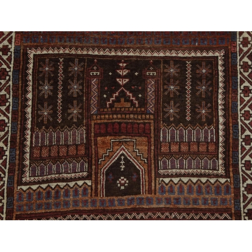 74 - Rectangular Middle Eastern prayer mat with geometric and floral border, the central field decorated ... 